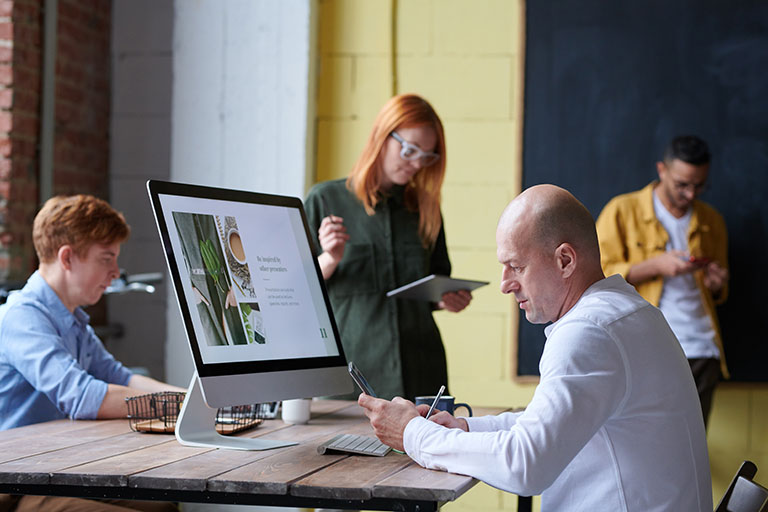 men and women working on computers during ADA training