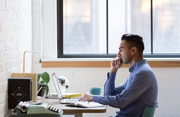 business man working on laptop trying to figure out if website is accessible