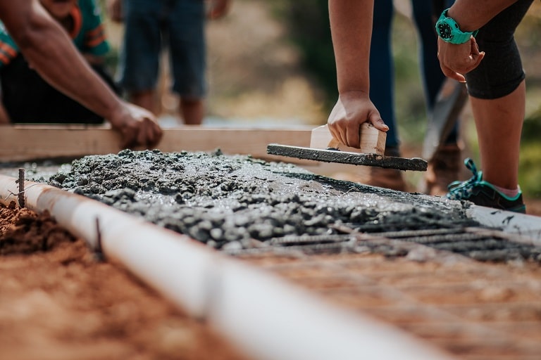 workers laying the foundation at a construction site