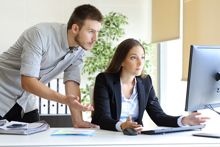 Upset businesspeople working with a computer