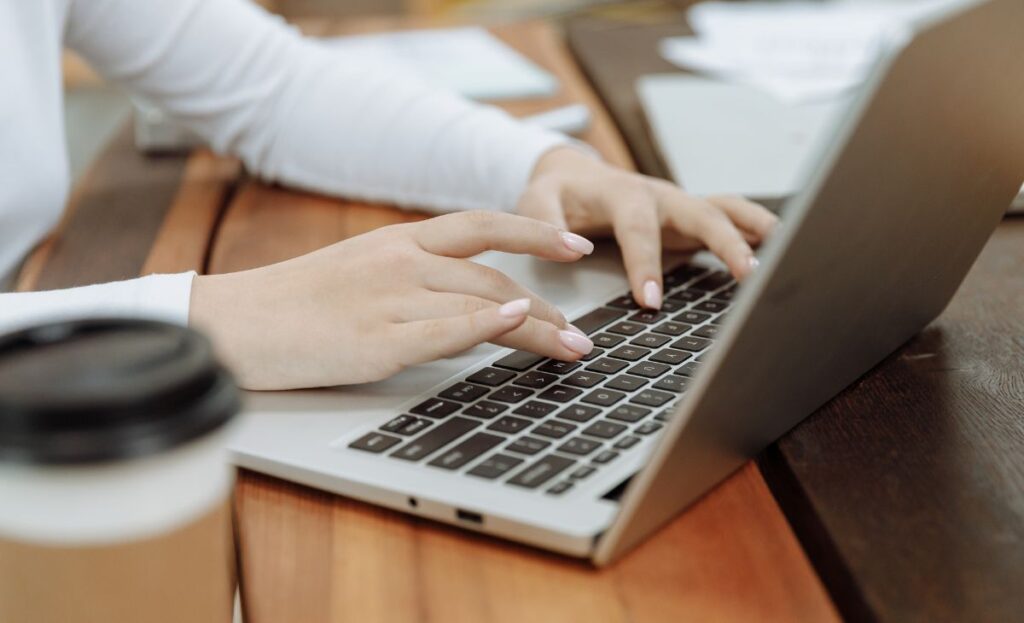 hands working on a laptop