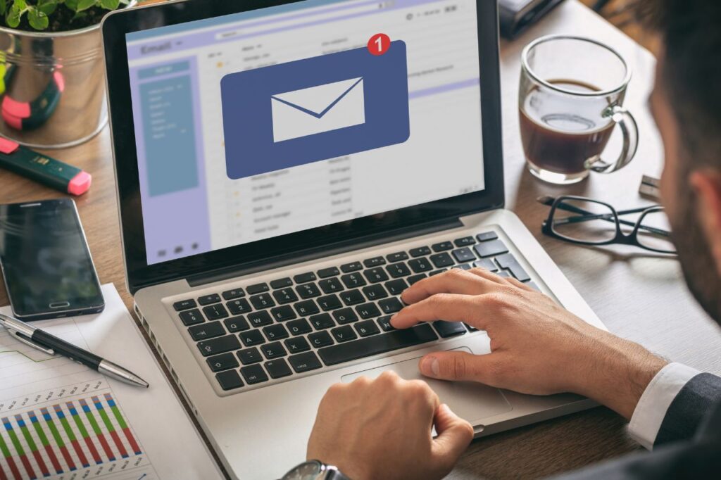 person opening an email on a laptop