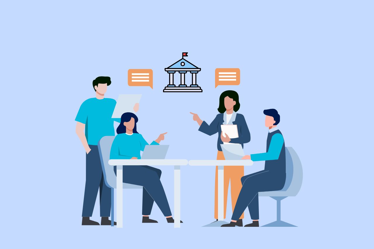 Team of four people having a discussion near a symbol of a government building